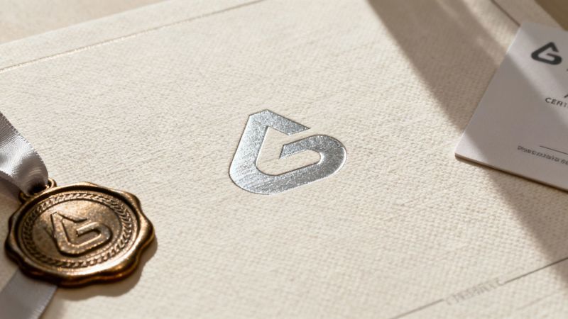 A close-up shot of a certificate with gold foil stamping and an embossed seal.